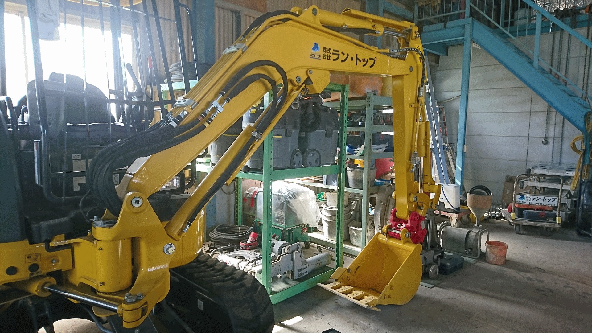 自社名入りの黄色いミニ油圧ショベル